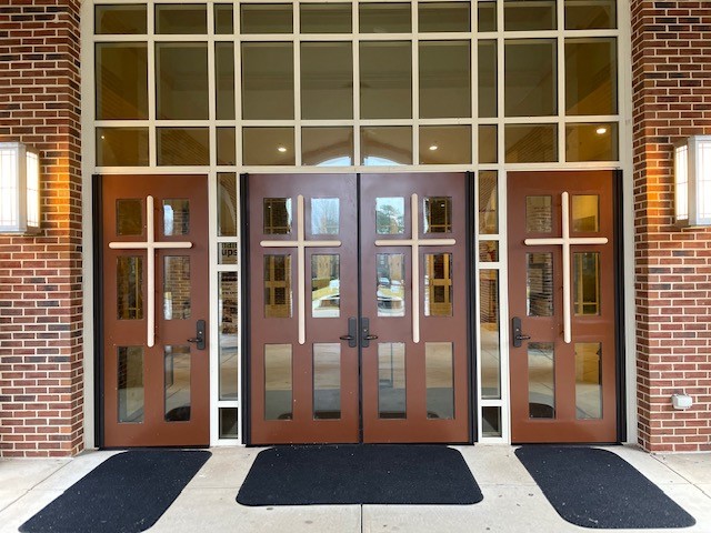 A church door with three sets of doors.